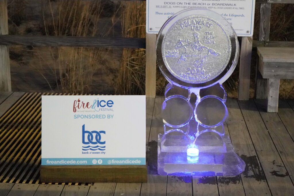 a sculpture of a coin on a wooden platform