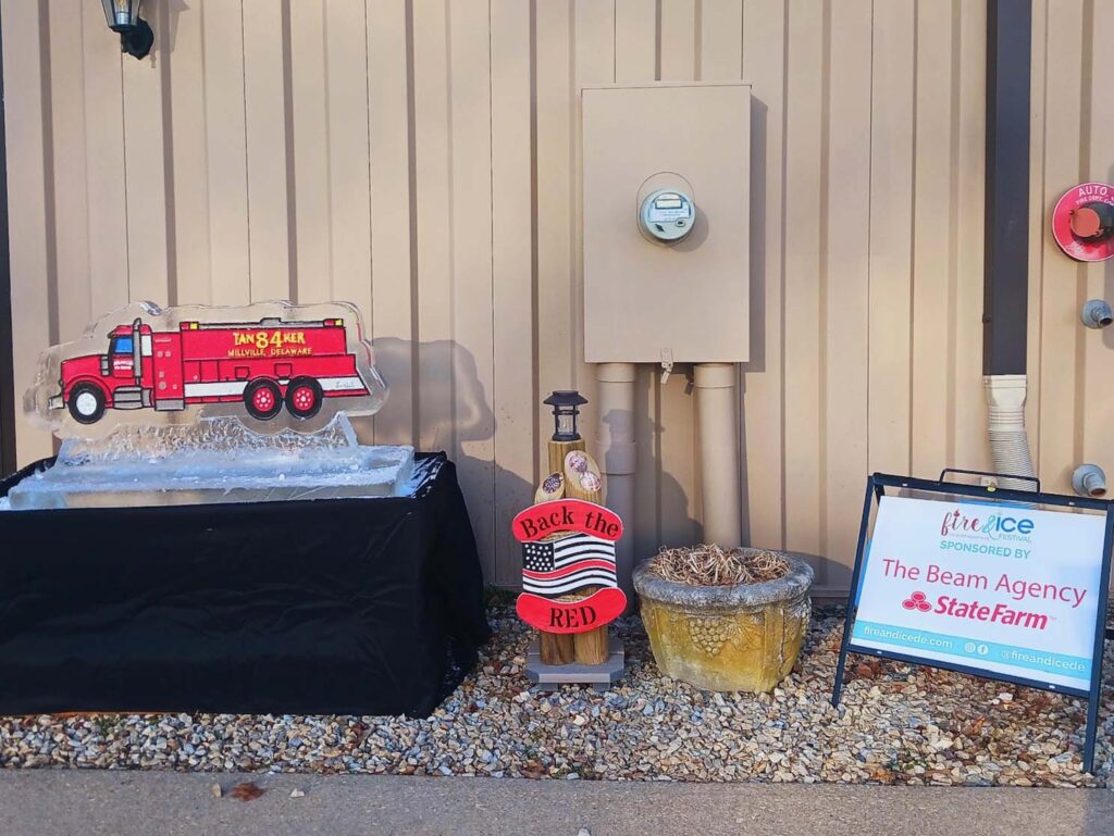 a table with a sign and a fire truck on it