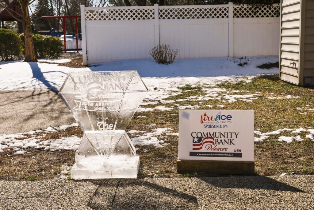 an ice sculpture in front of a white fence