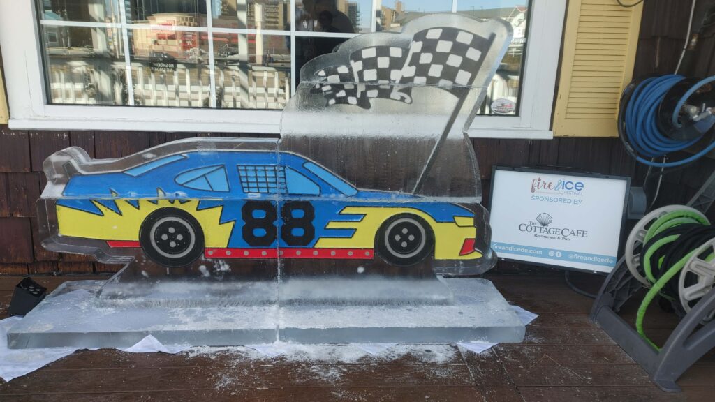a car shaped ice sculpture sitting in front of a store