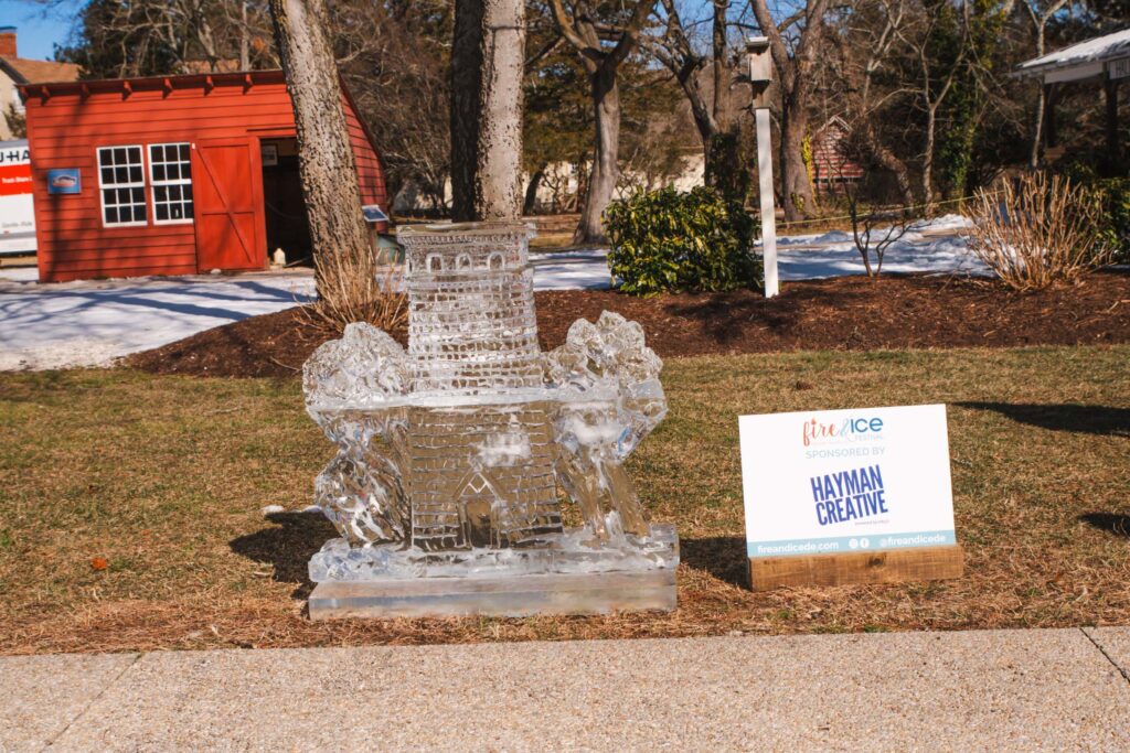 a water fountain in front of a red building