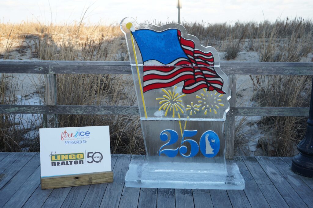 a statue of a flag and a sign on a wooden deck