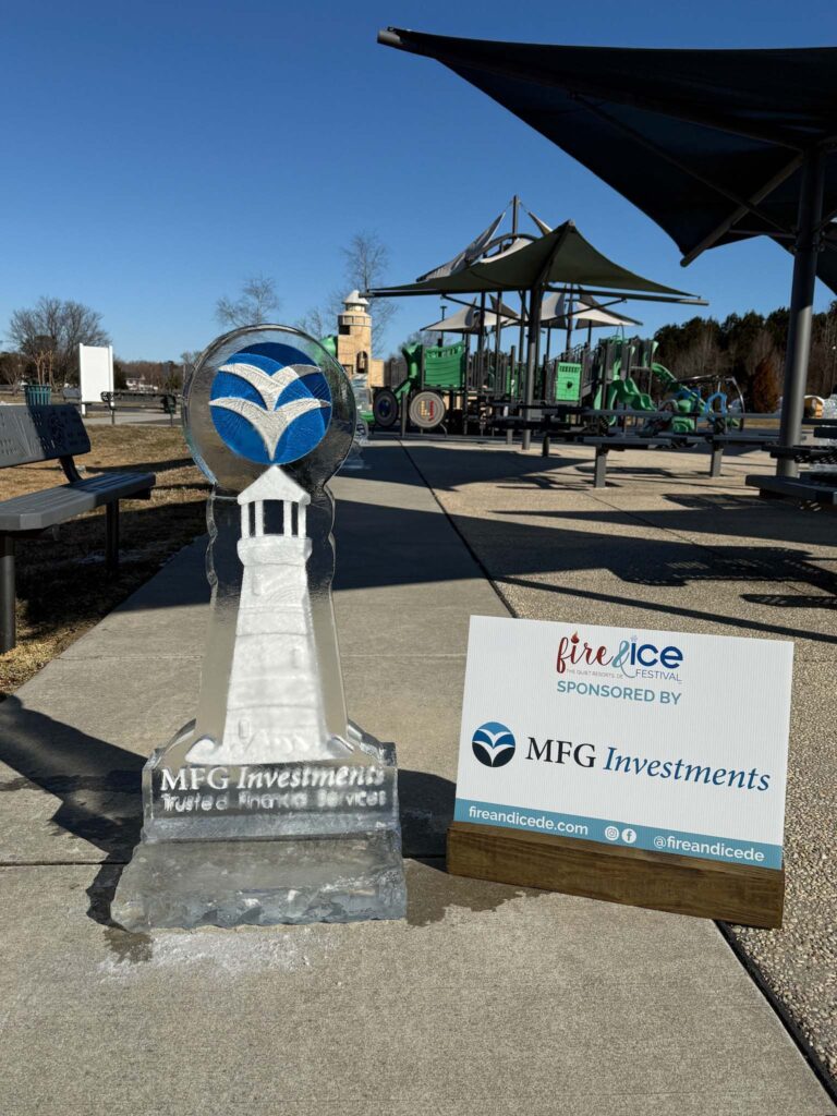 a statue of a clock on a sidewalk next to a sign