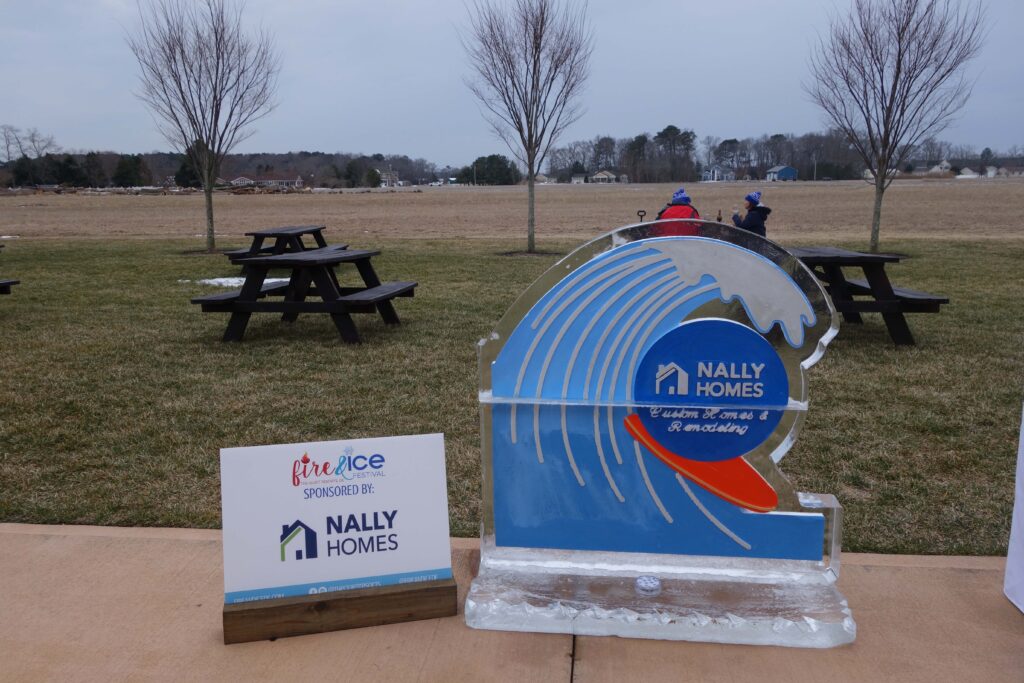a blue and white sign sitting on top of a cement slab