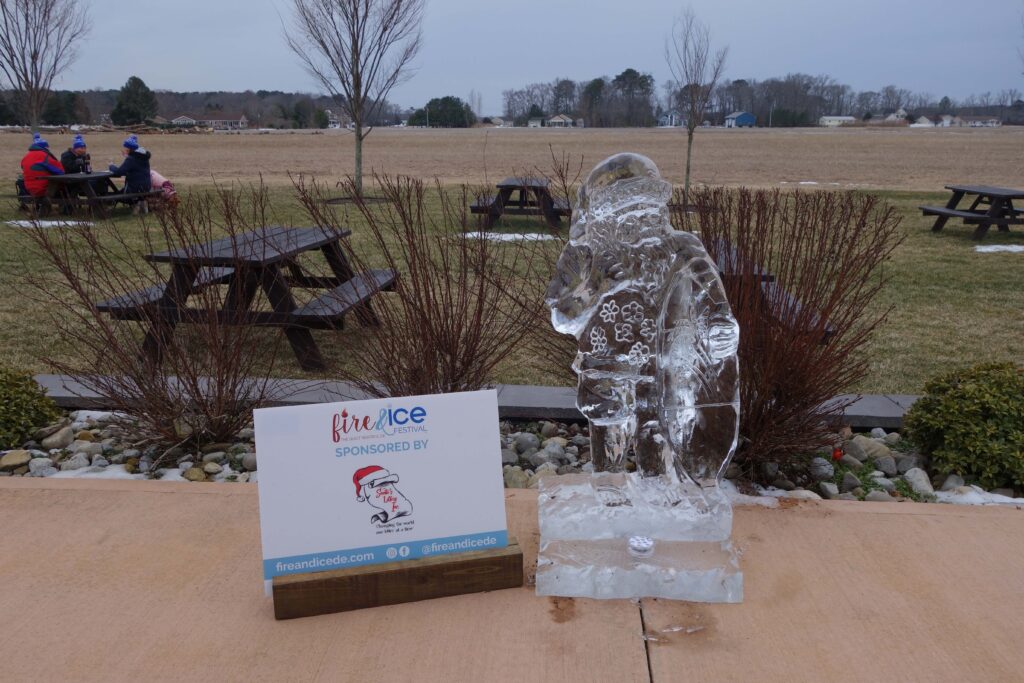 a statue of a man standing next to a sign