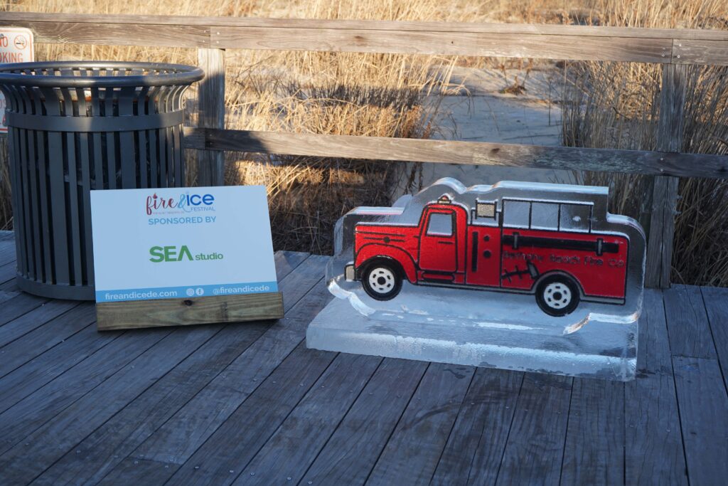 a red truck is on display on a wooden deck