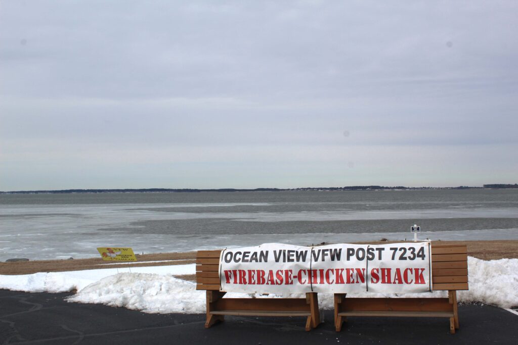 a couple of wooden benches sitting on top of snow covered ground