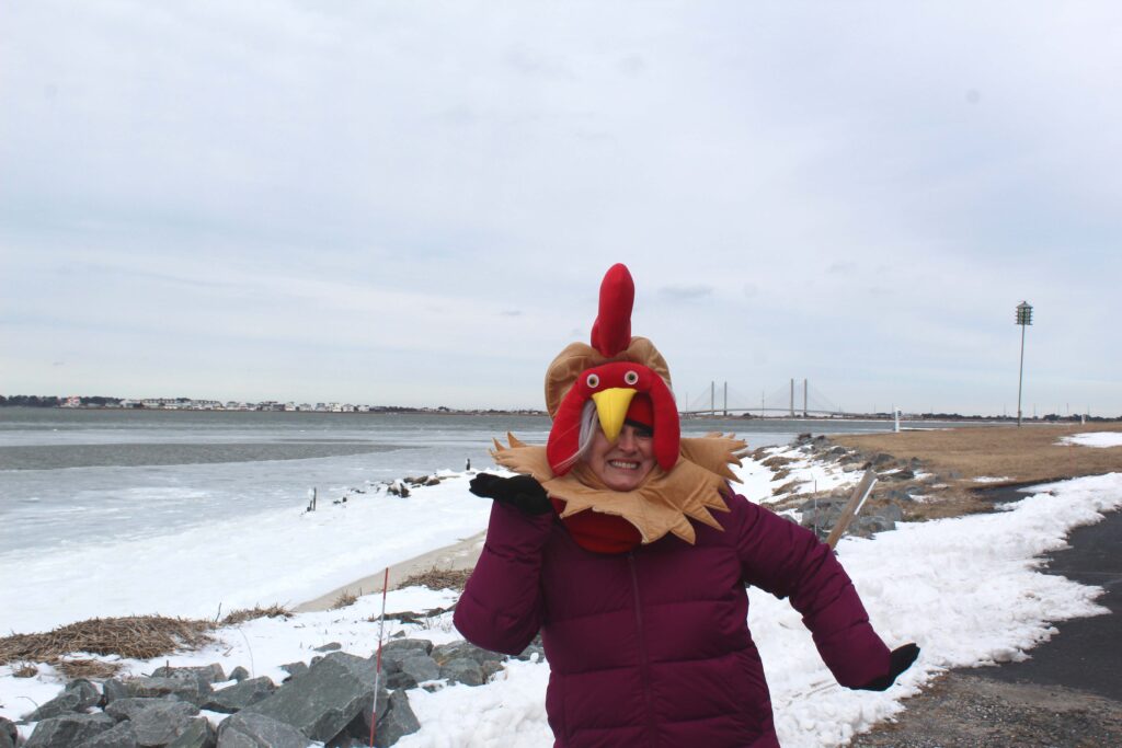 a woman in a turkey costume standing in the snow