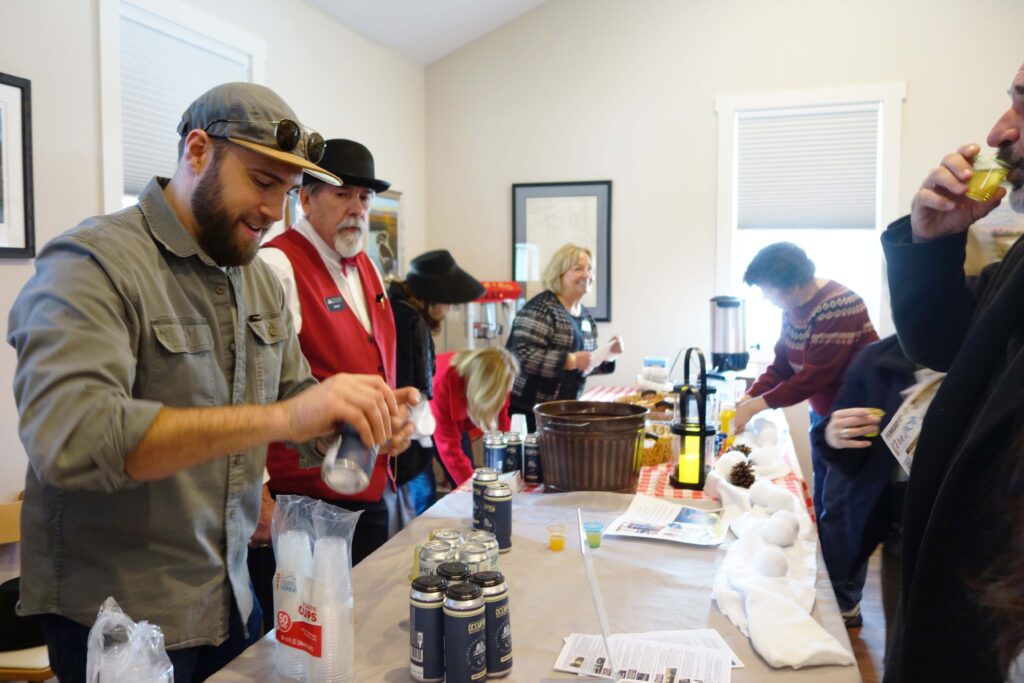 a group of people standing around a table