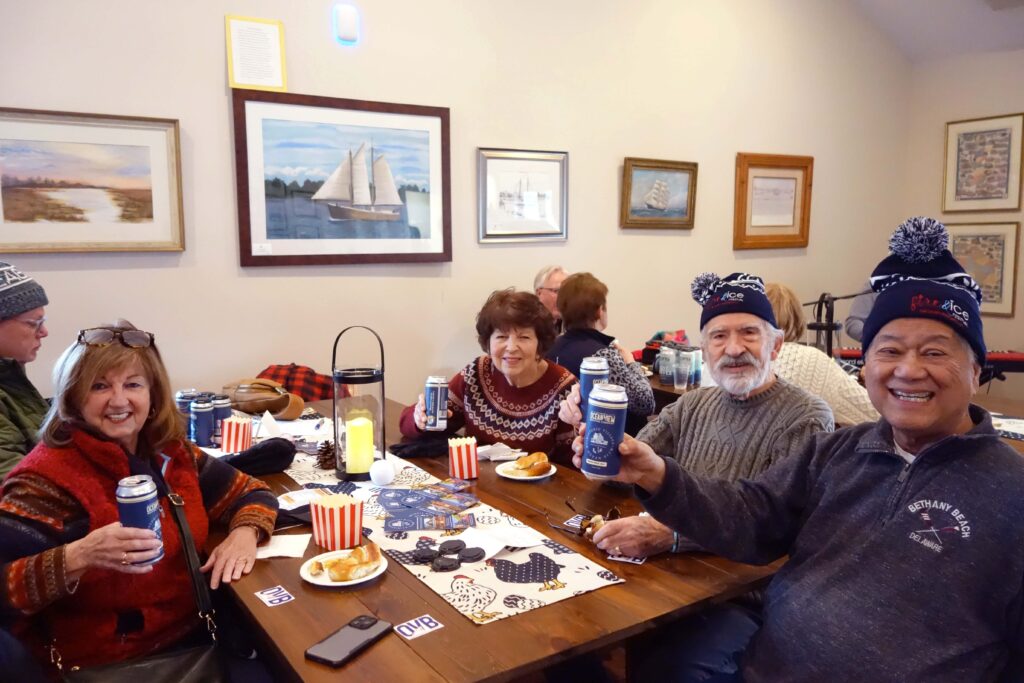 a group of people sitting around a wooden table