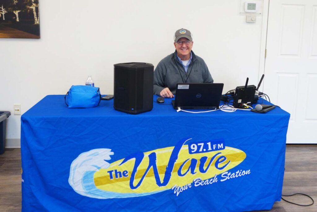 a man sitting at a table with a laptop