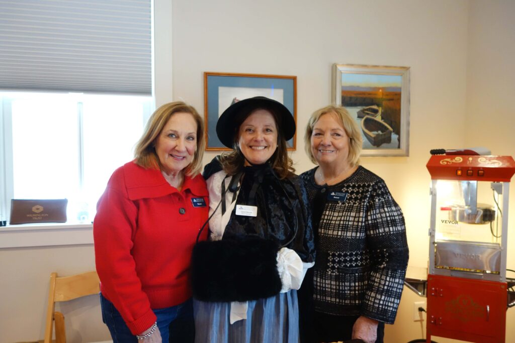 two women standing next to each other in a room