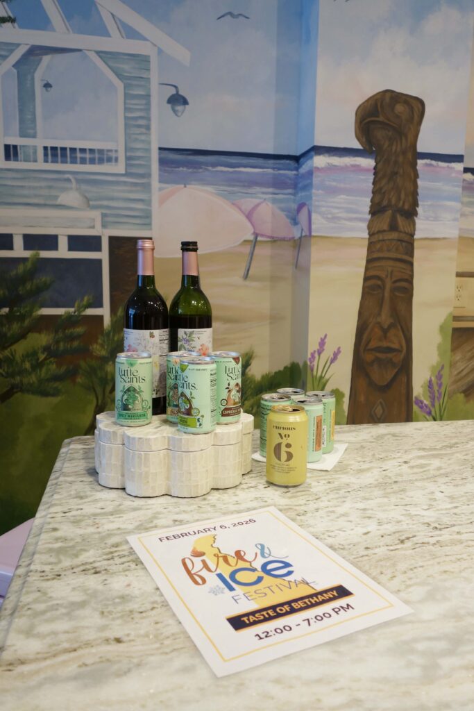 a counter top with a bottle of wine and some cans on it