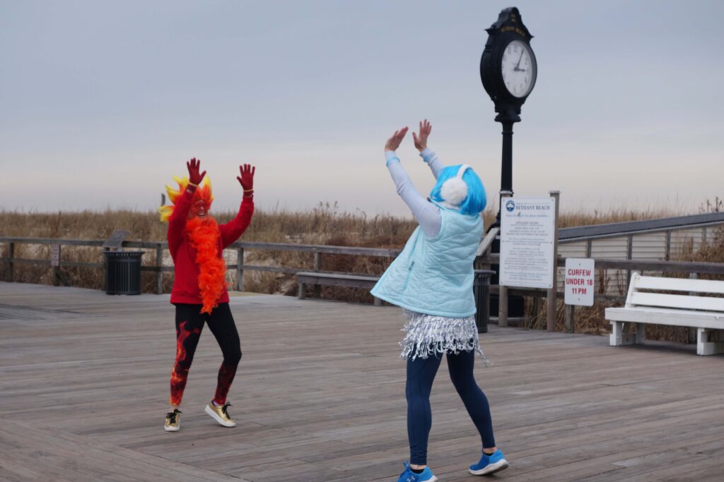 a couple of people that are standing on a dock