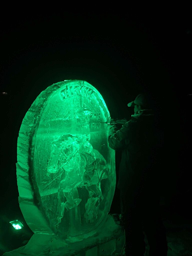 a man standing next to a large green object