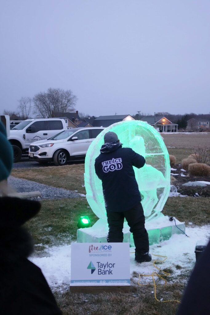 a man standing in front of a snow ball