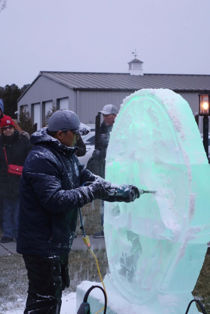 a group of people standing around a large ice sculpture