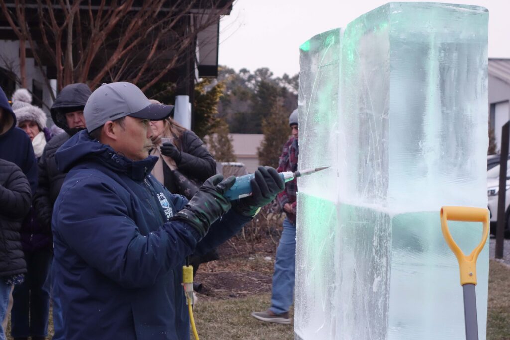 a man is working on an ice sculpture
