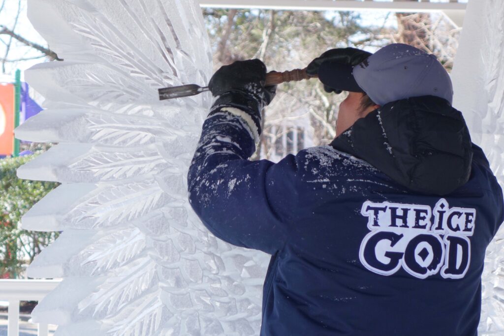 a man standing in front of an ice sculpture