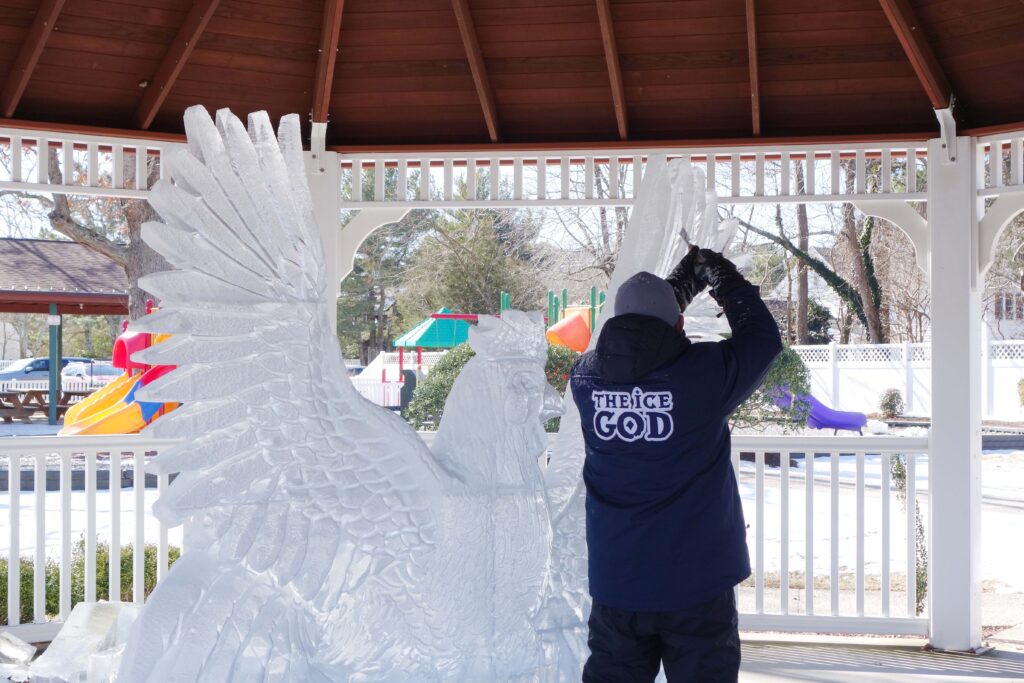 a man standing next to a statue of an angel
