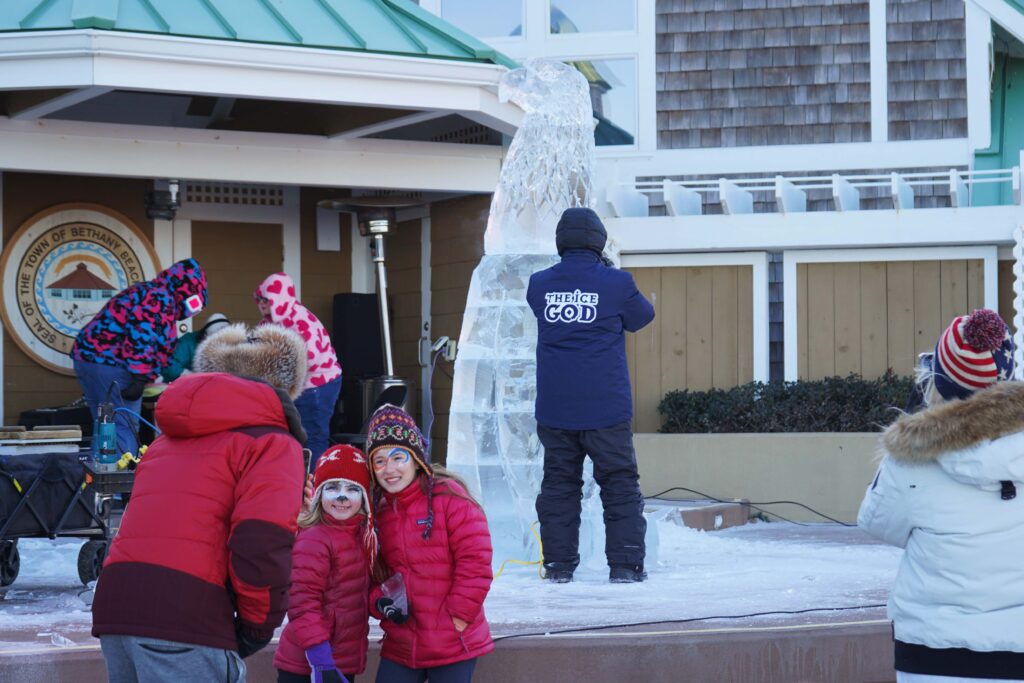 a group of people standing on top of a snow covered ground