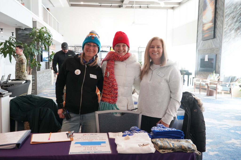 a group of people standing next to a table