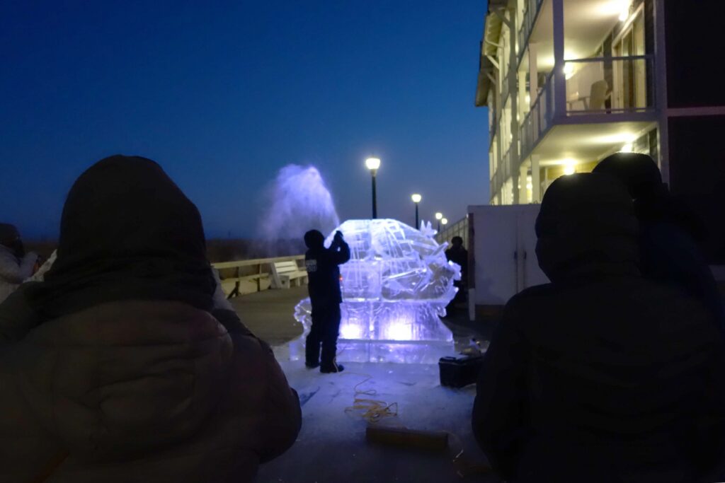 a group of people standing in front of a fountain