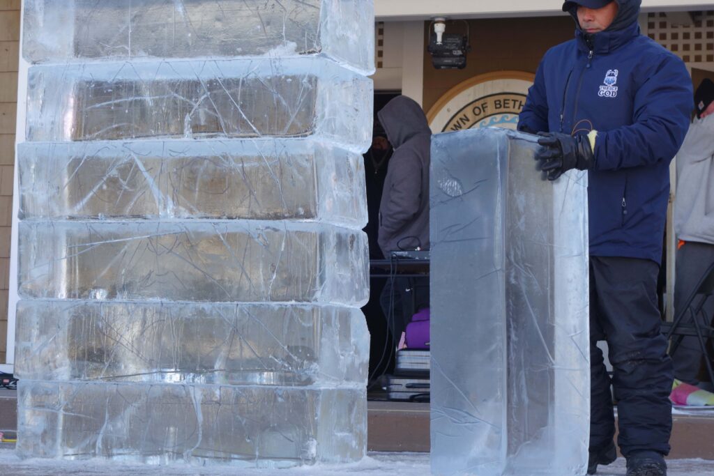 a man standing next to an ice sculpture