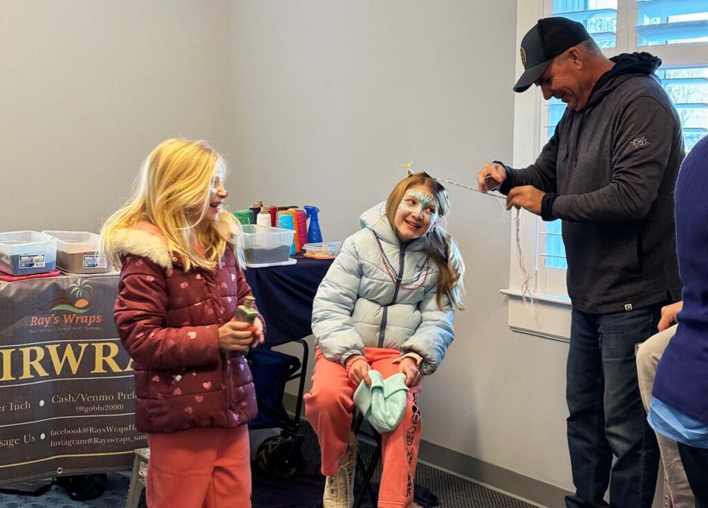 a group of people standing around a room
