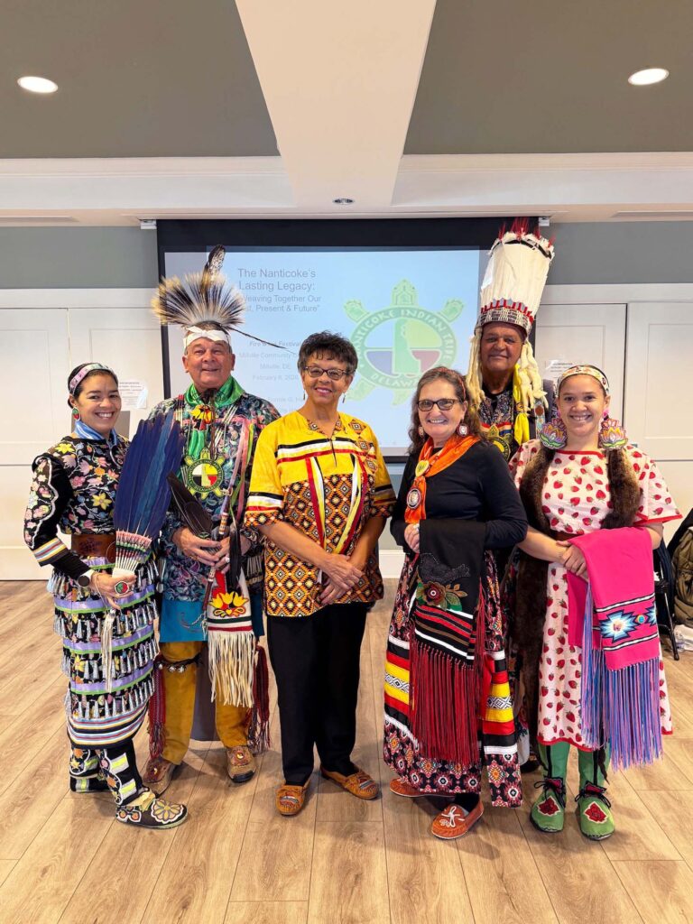 a group of people standing on top of a hard wood floor