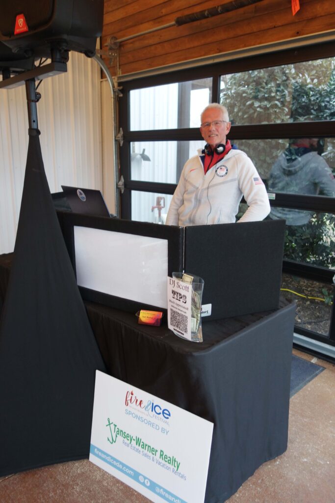a man standing behind a table with a sign on it