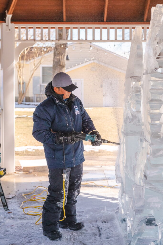 a man standing in front of an ice sculpture