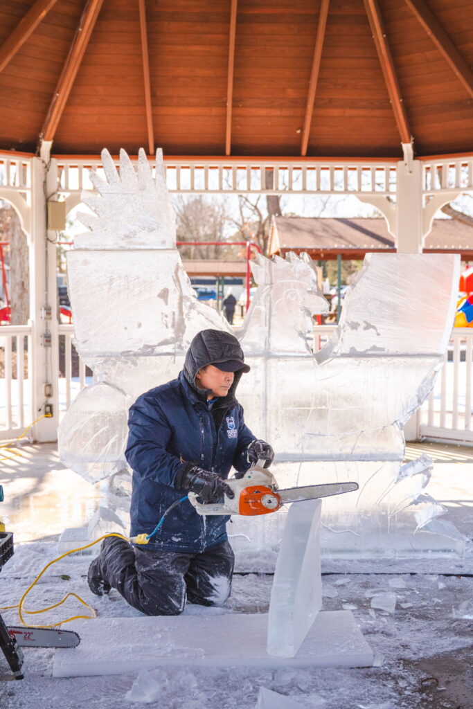 two men are working on a piece of ice
