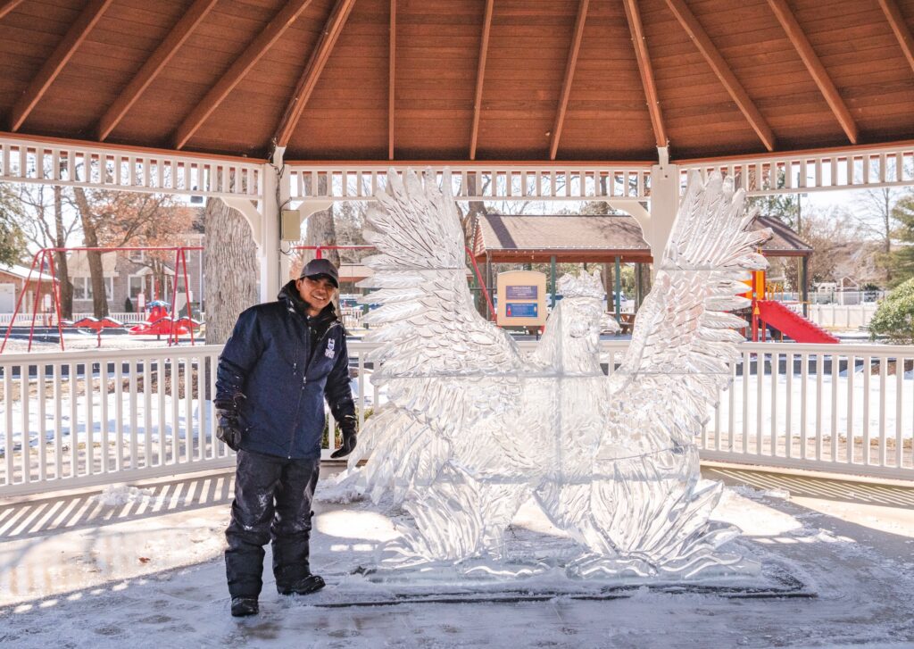 a man standing in front of a white sculpture