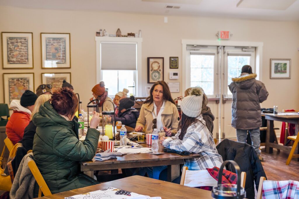 a group of people sitting around a wooden table