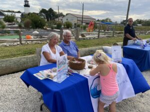 a group of people sitting around a table with food on it