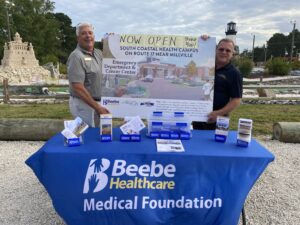 two men standing next to a table with medical items on it