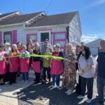 a group of people standing in front of a house
