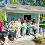 a group of people standing in front of a house