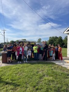 a group of people standing in front of a house
