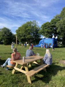 a group of people sitting at a picnic table