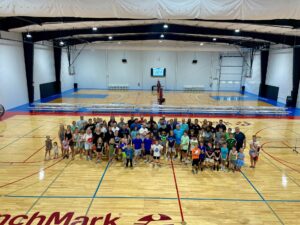a group of people standing on a basketball court