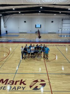 a group of people standing on a basketball court