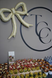 a table filled with lots of food next to a wall