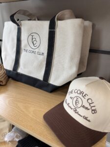 a couple of hats sitting on top of a wooden shelf