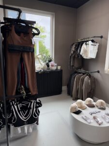 a clothing store with clothing and accessories on display