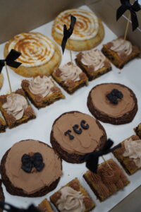 a table topped with lots of cakes and cookies