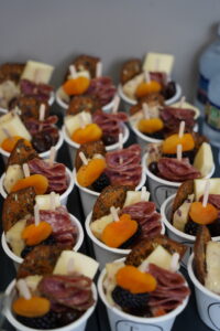 a table topped with cups filled with different types of food