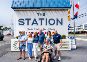a group of people standing in front of a sign