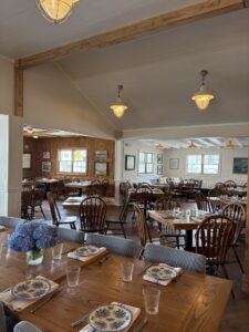 a dining room with wooden tables and chairs